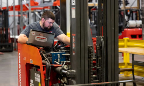 Carolina Handling Technician repairing Raymond Forklift
